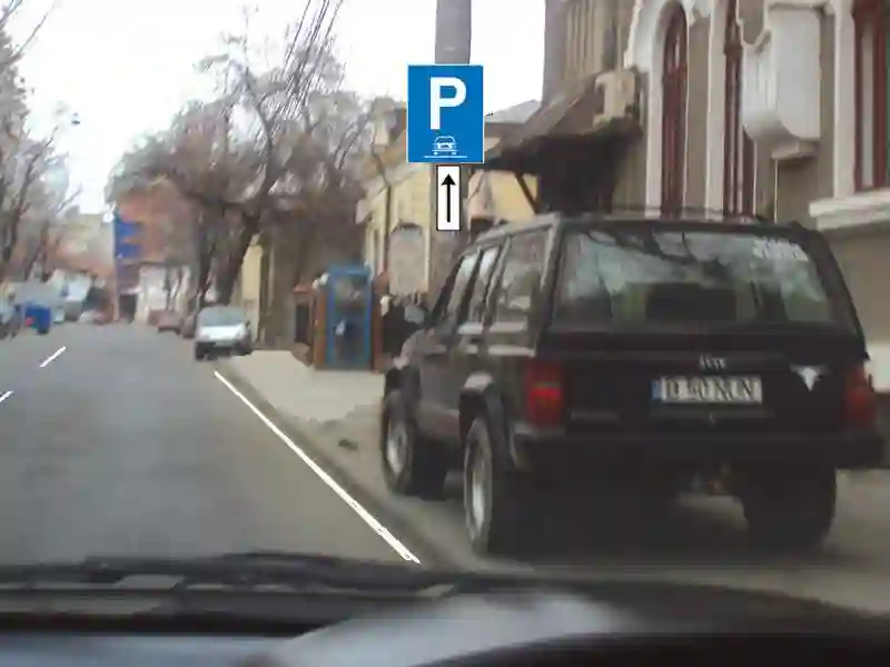 Imagine întrebare examen auto: Autoturismul din imagine a parcat regulamentar?